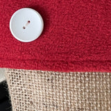 BurlapBabe Christmas stocking detail featuring natural jute burlap, a soft red fleece cuff, and a white wooden button.