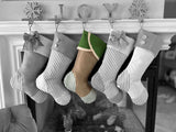 BurlapBabe green ticking and burlap Christmas stockings hanging on a fireplace mantel with festive decor.