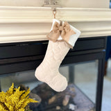 BurlapBabe quilted Christmas stocking with a white fleece scallop cuff and a rustic natural burlap bow hanging.