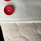 BurlapBabe quilted Christmas stocking featuring ivory cotton fabric, a soft fleece cuff, and two red wood buttons.