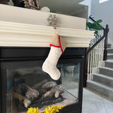 BurlapBabe quilted Christmas stocking with a natural burlap cuff and red cotton trim hanging on a fireplace mantel.