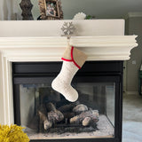 BurlapBabe quilted Christmas stocking with a natural burlap scallop cuff and red cotton trim hanging on a fireplace mantel