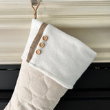 BurlapBabe quilted Christmas stocking in cream fabric with white cuff, wood buttons, and a braided jute hanging loop.