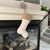 BurlapBabe quilted Christmas stocking with a burlap cuff and wooden buttons hanging from a fireplace mantel