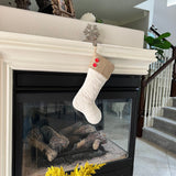 BurlapBabe quilted cotton Christmas stocking with a natural burlap cuff and two red wood buttons hanging on a mantel.