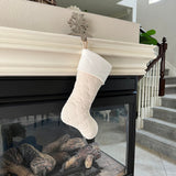 BurlapBabe quilted cream Christmas stocking with a soft white fleece cuff hanging from a fireplace mantel