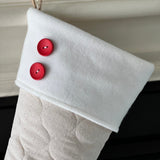 BurlapBabe quilted ivory cotton Christmas stocking with a white fleece cuff and two decorative red wood buttons.