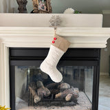 BurlapBabe quilted white cotton Christmas stocking with a natural burlap cuff and two red wood buttons on a mantel