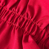 Close-up of the bright red cotton ruffle cuff on a BurlapBabe quilted Christmas stocking with hemmed edges.