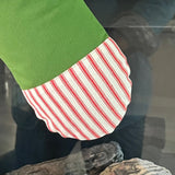 BurlapBabe red and green Christmas stocking featuring a striped fabric cuff and off-white muslin lining.