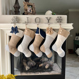 Set of five BurlapBabe Christmas stockings with burlap, blue ticking, and muslin, hanging on a fireplace mantel