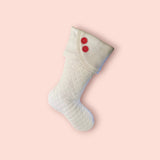BurlapBabe white quilted Christmas stocking with fleece scalloped cuff and two red wooden buttons hanging on fireplace